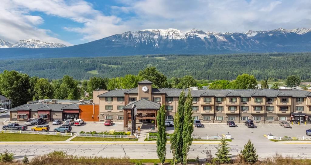 a hotel with a parking lot and mountains in the background at Prestige Golden Hotel in Golden