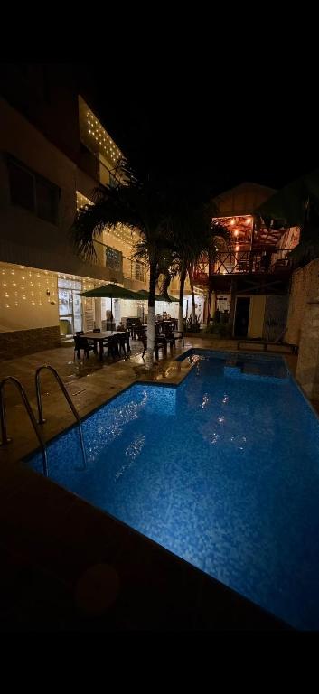 a large blue swimming pool in a building at night at Apartamentos Isla Tropical in San Andrés