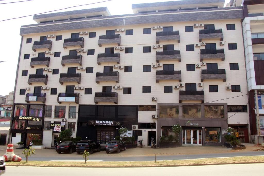 a large white building with balconies on it at AZURA Skyline in Abidjan