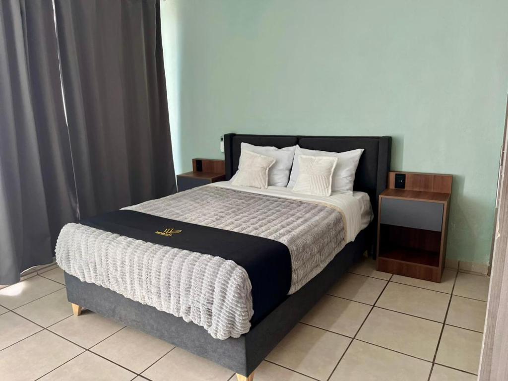 a bedroom with a large bed with white pillows at 2 VENATOR House Boutique in León