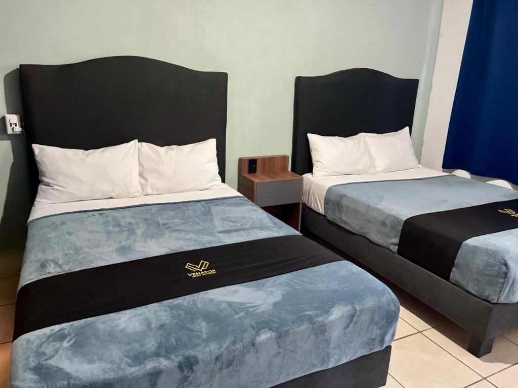 a hotel room with two beds in a room at 4 VENATOR House Boutique in León
