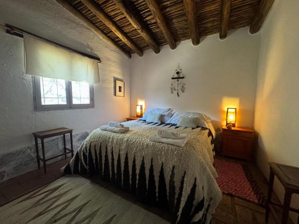 a bedroom with a bed with two towels on it at El Caserío Jujuy in Volcán