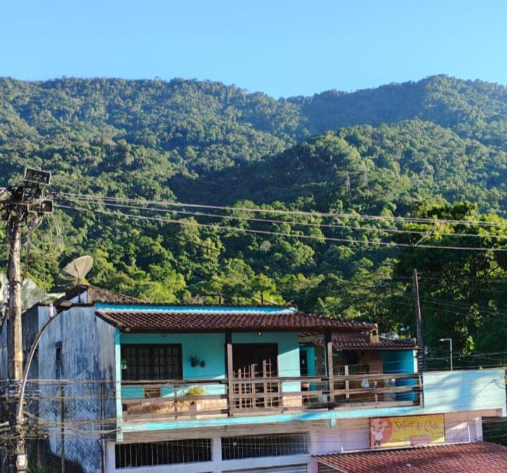 a house on top of a hill with a mountain at Casa Ampla Vila Muriqui in Vila Muriqui