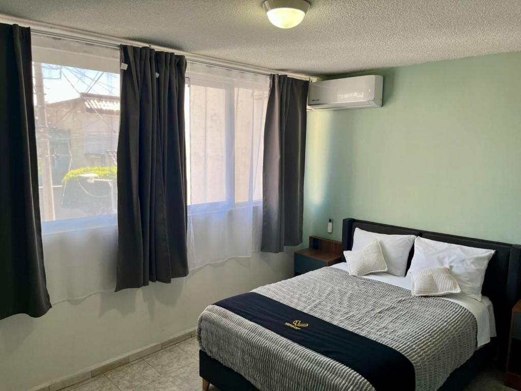 a bedroom with a bed and a window with curtains at 6 VENATOR House Boutique in León