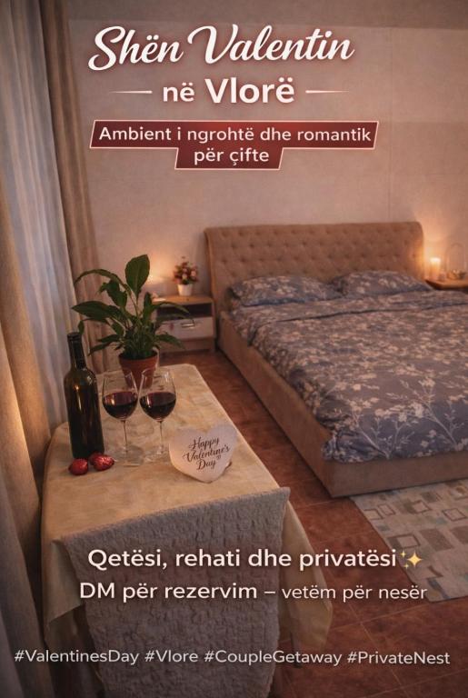 a room with a bed and two glasses of wine at Tonia&Sion in Vlorë