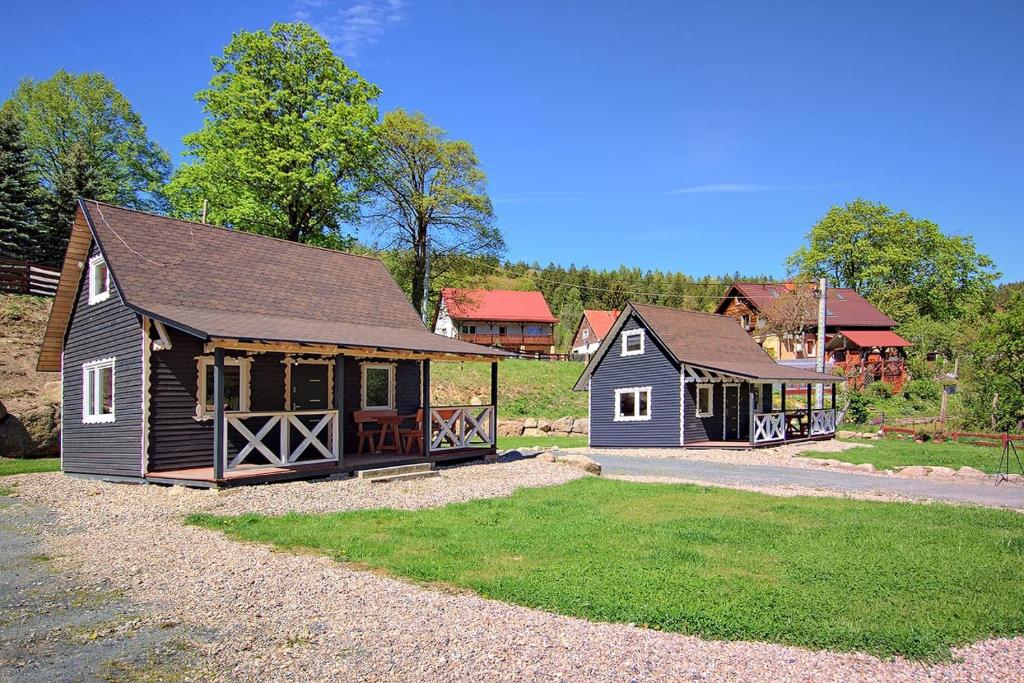 a home with a barn and a house at Dziedziniec Karkonoszy in Podgórzyn