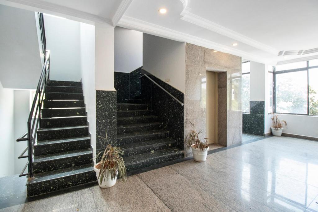 a staircase in a house with potted plants at OYO 70156 Victorian Comforts in Bangalore