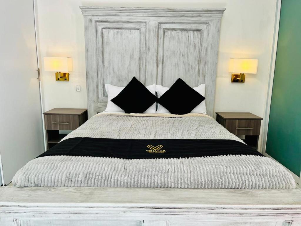 a bedroom with a large bed with two night stands at 12 VENATOR House Boutique in León