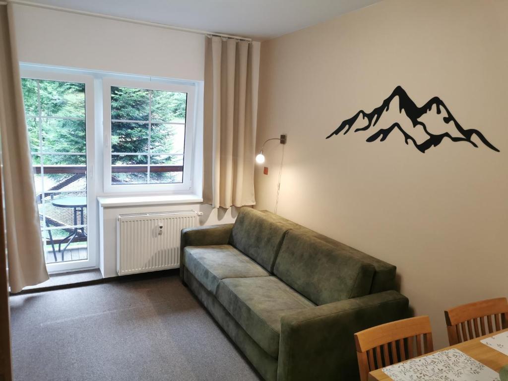 a living room with a couch and a window at Rodinný Špic in Špičák