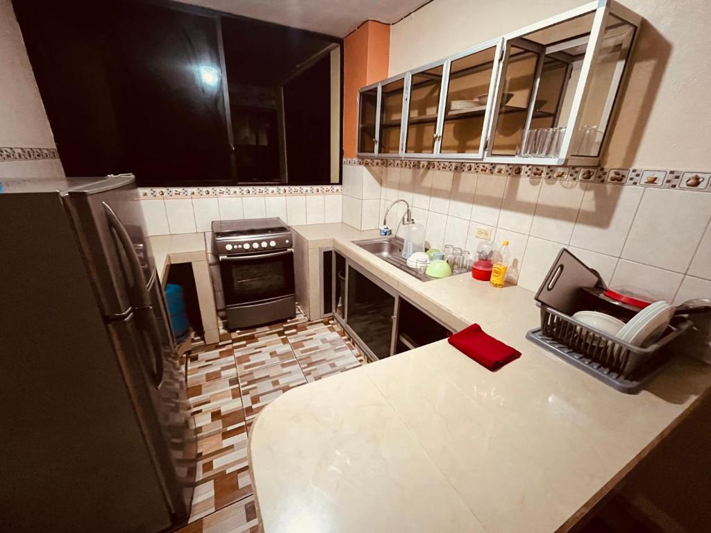 an overhead view of a kitchen with a stove and a counter at Apt 1 in Tena