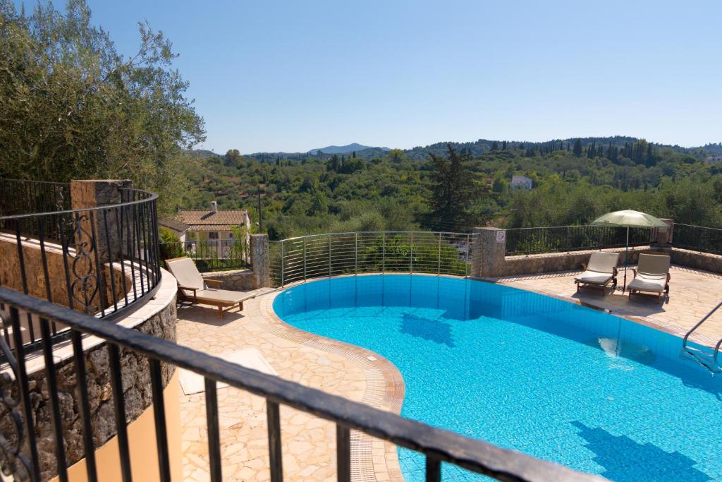 a swimming pool on the balcony of a house at Villa Odyssey Verde in Dassia