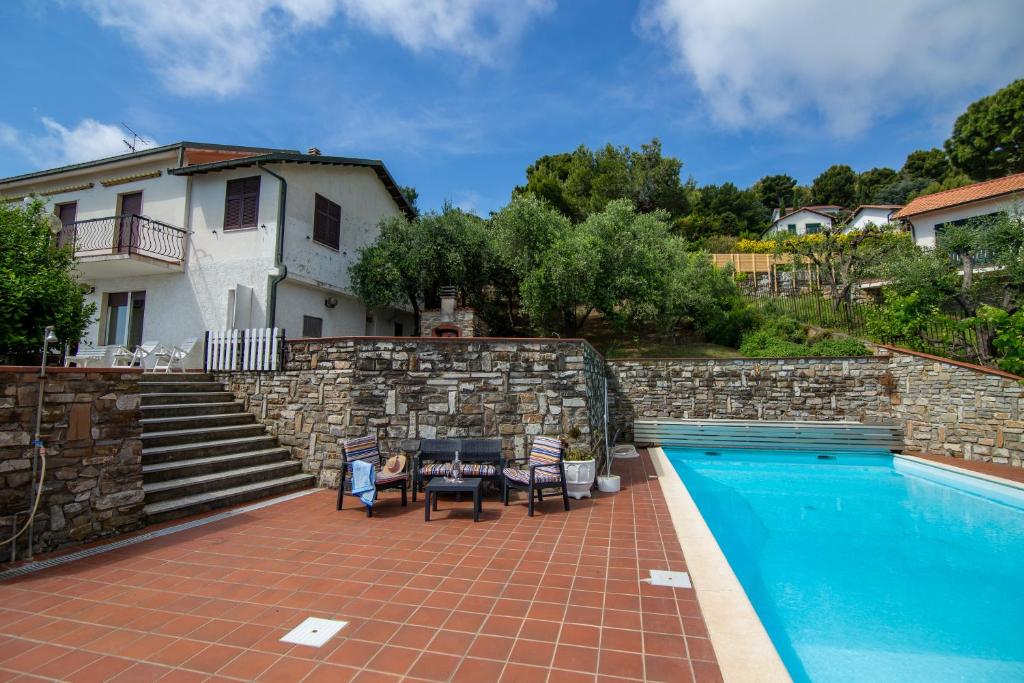 a villa with a swimming pool and a house at Villa Ciacia in Cervo