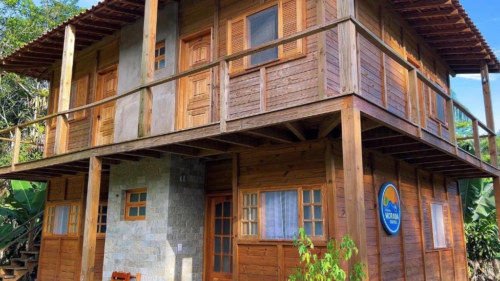 a wooden house with a balcony on top of it at Morada do Sol Petar in Iporanga