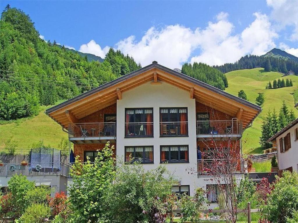 a large building with a mountain in the background at Apartment Höfer by Interhome in Schröcken