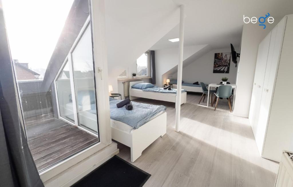 a bedroom with a bed and a table in a room at BEGE APARTMENTS FlowLoft in Wegberg