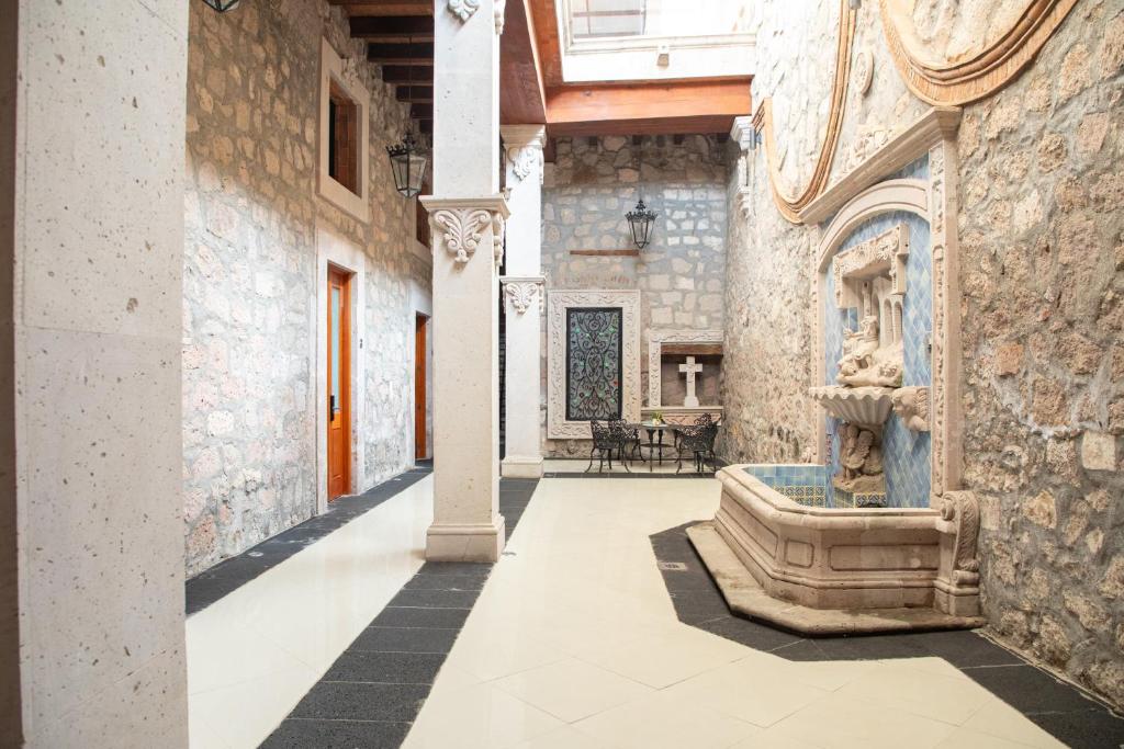 a courtyard with a fountain in a building at Casa Serdán, Suites & Events in Morelia