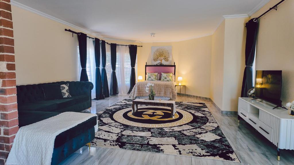 a living room with a bed and a couch at L a Grande deluxe in Benoni