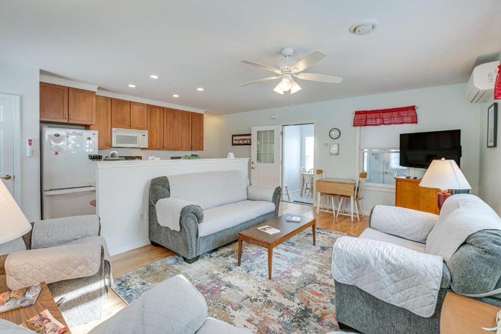 a living room with couches and a kitchen at Unbeatable Downtown Location! Bar Harbor Apt in Bar Harbor