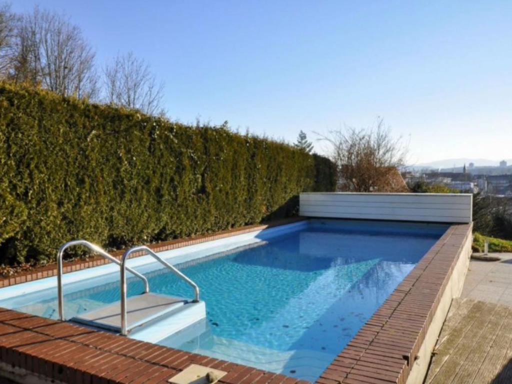 a swimming pool on top of a brick wall at Holiday Home mit Pool by Interhome in Nürtingen