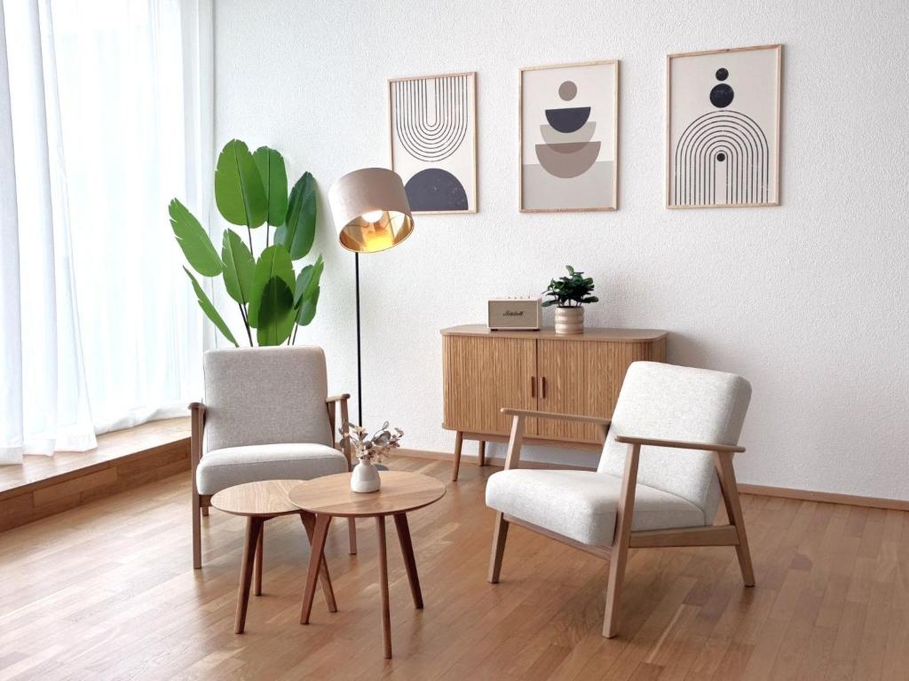 a living room with two chairs and a table at Apartment Loft Seven by Interhome in Root