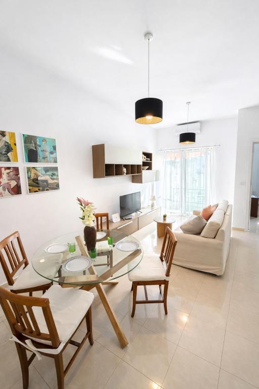 a living room with a table and chairs and a couch at Twin Apartment in St. Julianʼs