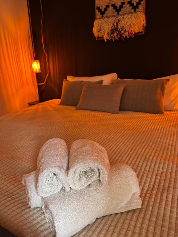 a bed with white towels on top of it at The Nest, Apartament in Oświęcim