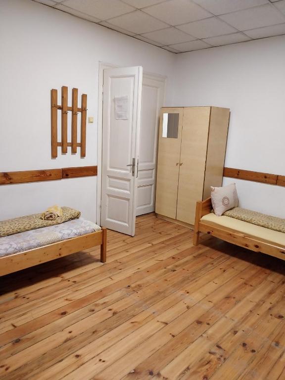 a room with two beds and a refrigerator at Скай Румс -2 in Sofia