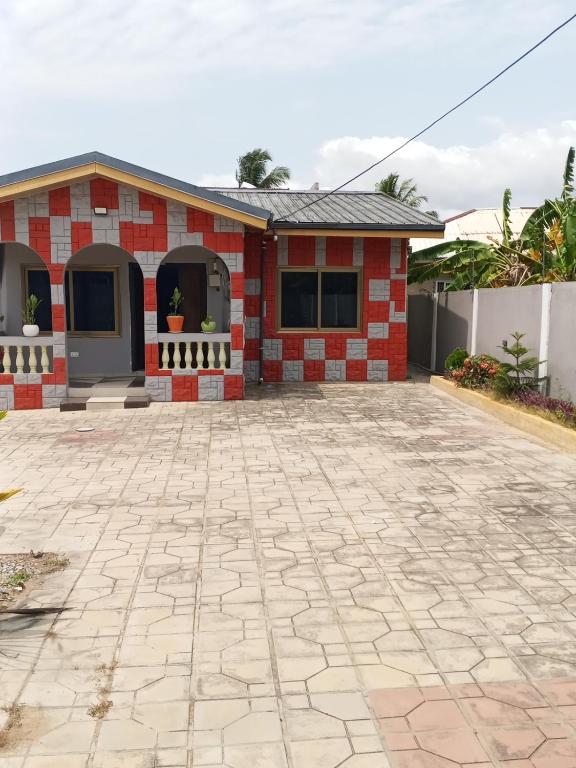 a red brick house with a stone driveway at El-Edu Villa in Oshien
