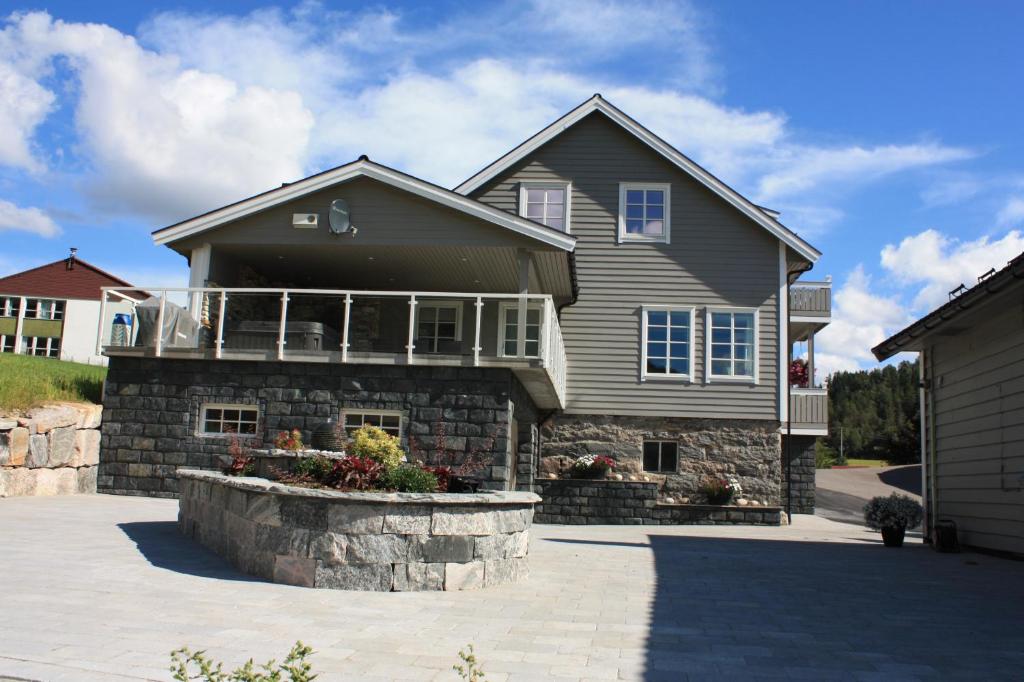 a large house with a porch and a patio at Viken Holiday Home in Viksdalen