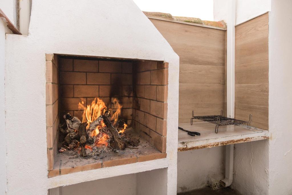 a brick oven with a fire in it at Casa Abilio Rodenas in Alborea