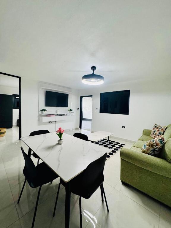a living room with a table and a couch at Brand New Luxe 2BR Apt Near SJU & Airport in Carolina