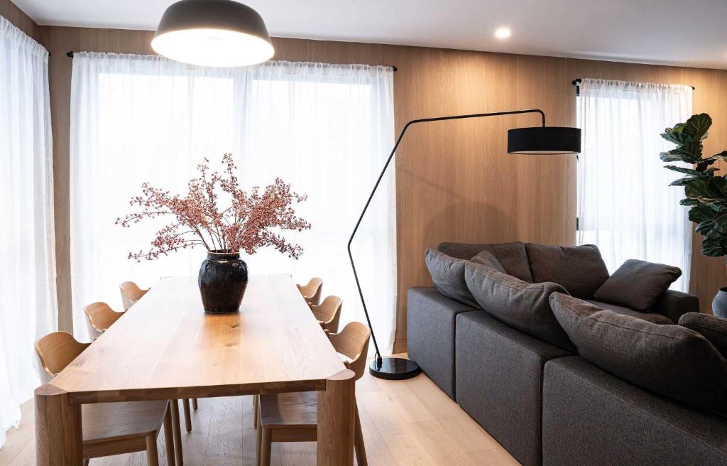 a living room with a table and a couch at Luna Ridge - Thoughtfully Designed 3-Bedroom Condo in Revelstoke