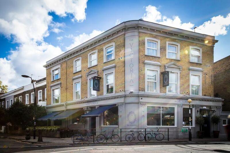 a large brick building on the corner of a street at Victoria Inn in London