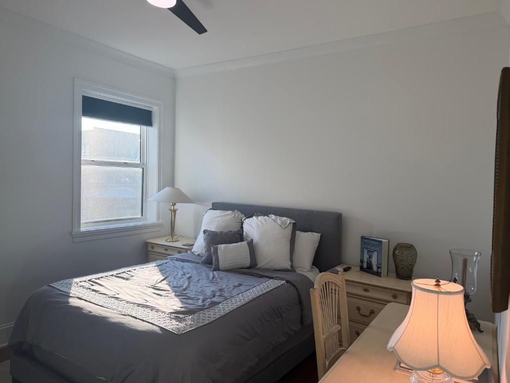 a bedroom with a bed and a window at The Lyons' Den in Chicago