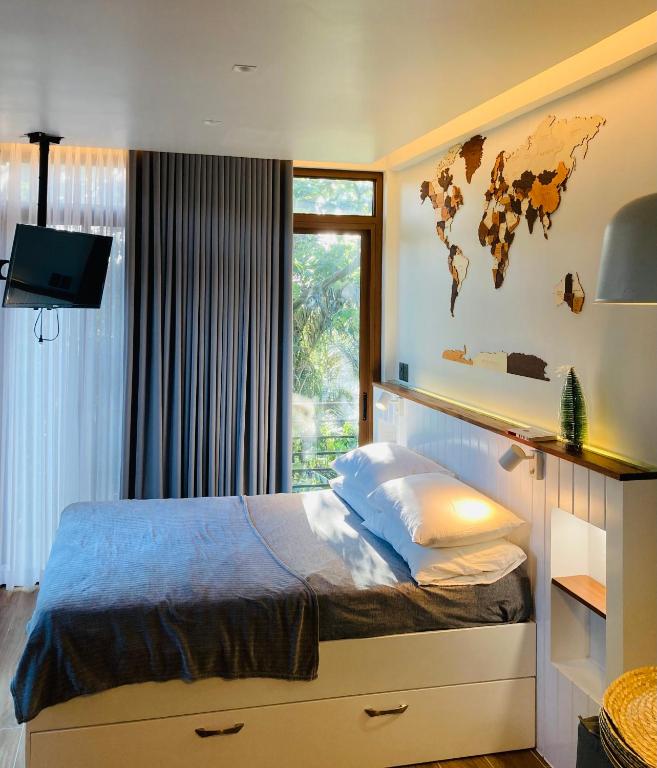 a bedroom with a bed with a map on the wall at Casa Yvanna in Alfonso