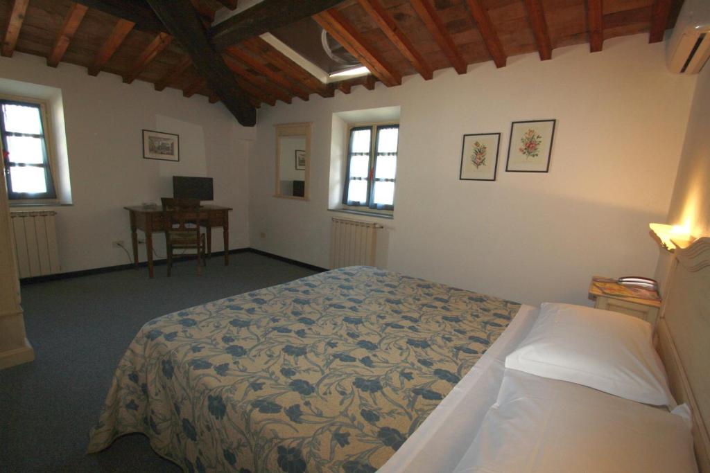 Postel nebo postele na pokoji v ubytování Hotel Calzaiolo