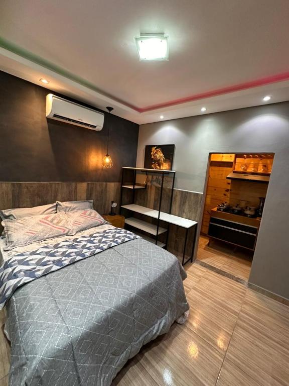 a bedroom with a bed and a dresser in it at Gold Stay Residence 2 in Belo Horizonte