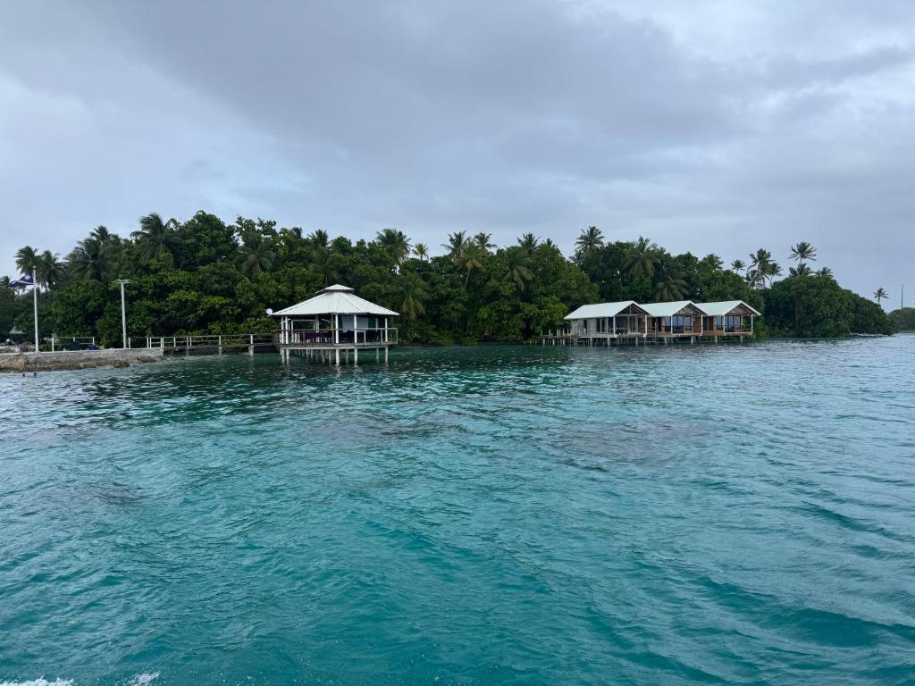 a group of houses on an island in the water at Bokanbotin Island Resort in Majuro