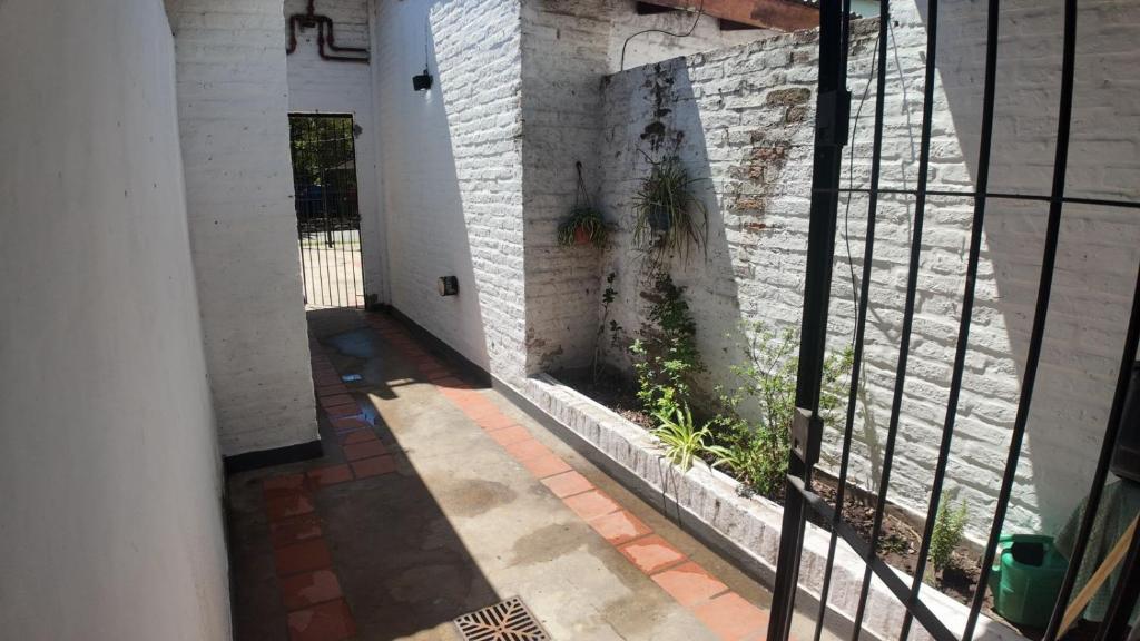 an empty hallway of a building with a window at Departamento Escobar in Belén de Escobar