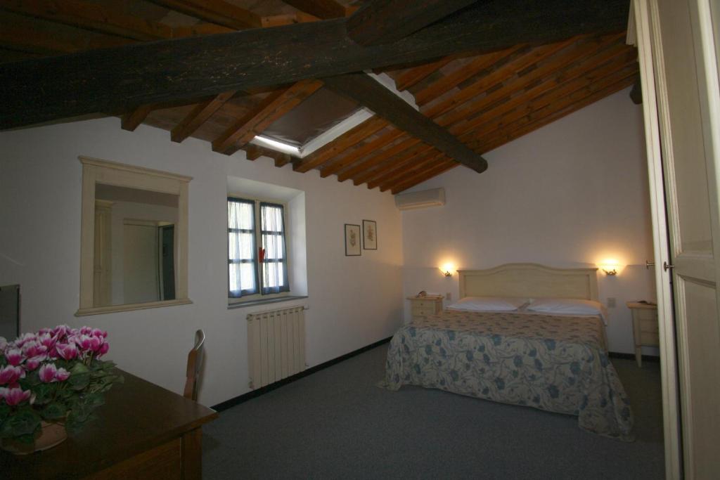 Postel nebo postele na pokoji v ubytování Hotel Calzaiolo