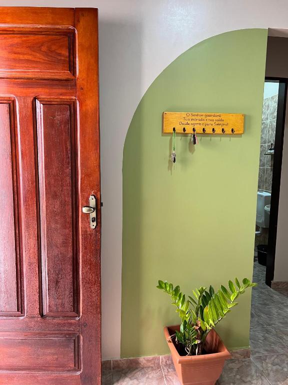 a door in a room with a plant in a pot at Casa ao lado do Sebrae in Macapá