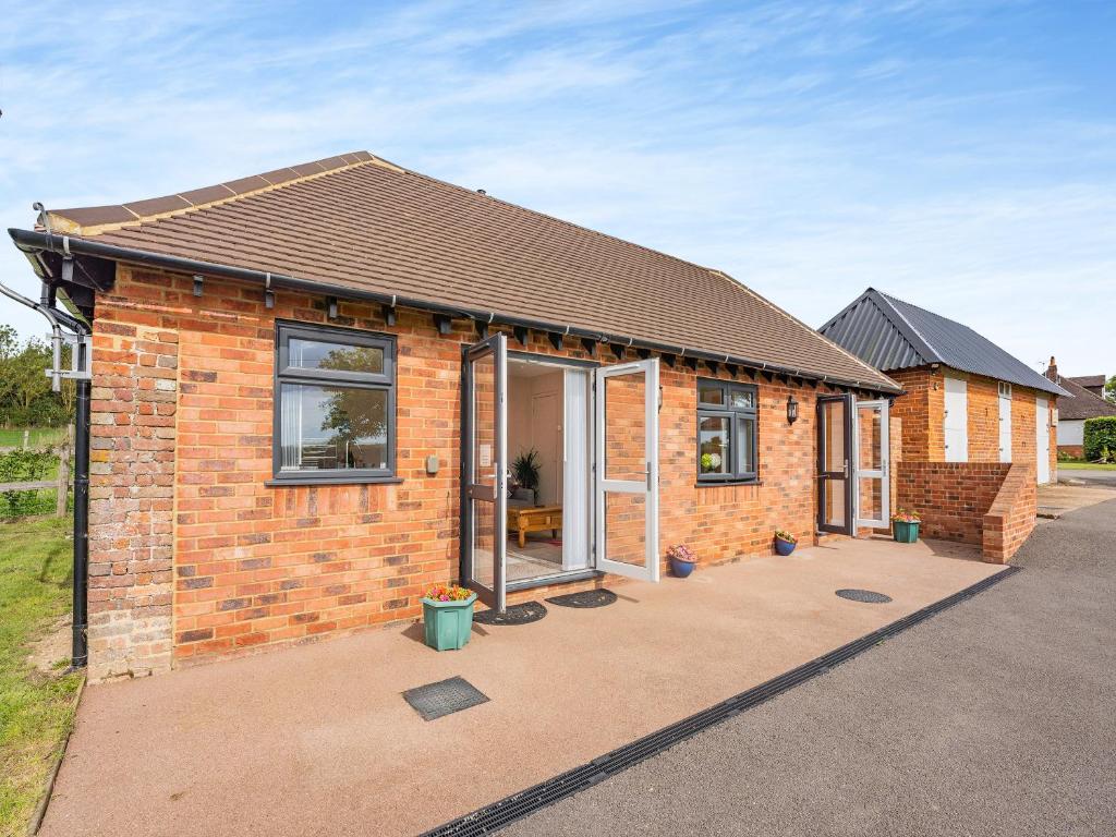 a brick house with windows and a roof at Jemmett Lodge in Kent
