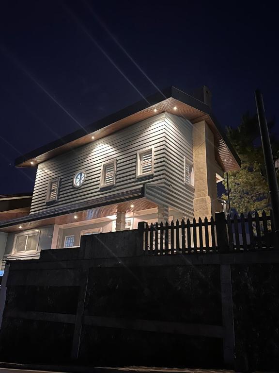 a house with a clock on the side of it at Talna in Baguio