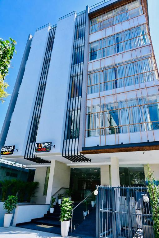 a building with a gate in front of it at Lumis Hotel Whitefield in Bangalore