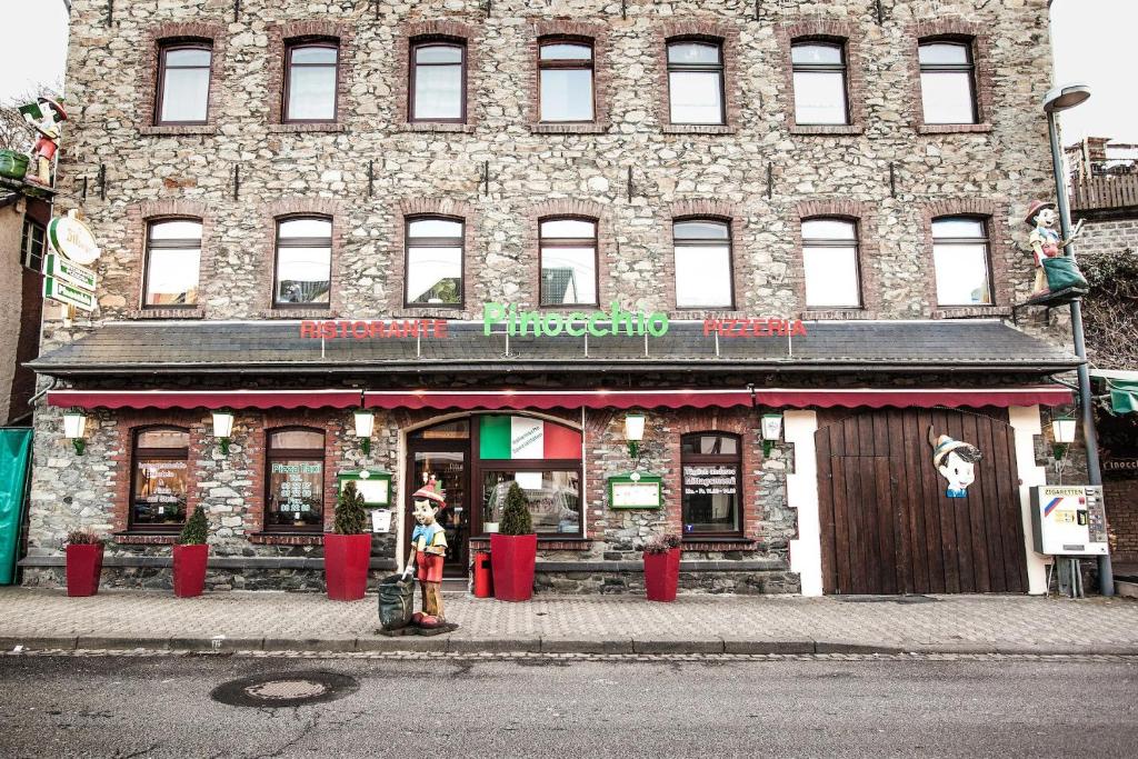 a building on the corner of a street at Nurburgring Rooms Pinocchio in Adenau