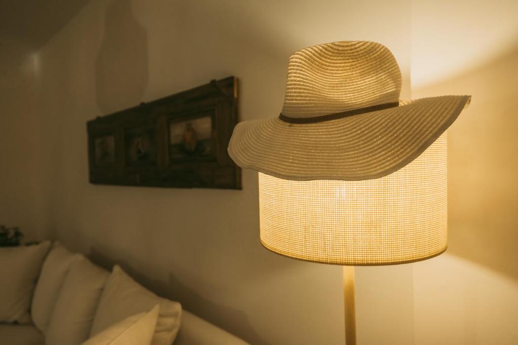 a hat sitting on a lamp in a living room at Maelia Samos Apartment in Ríva
