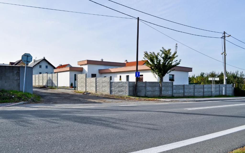 BudimírにあるMini Motelの柵と家屋が並ぶ空き道