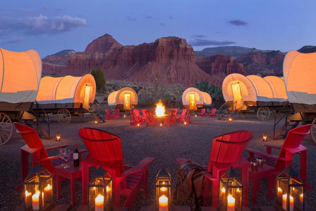 a group of red chairs and a fire in the desert at Capitol Reef Resort in Torrey