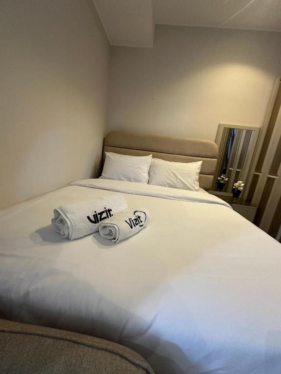 a bedroom with a bed with towels on it at Fully Furnished Hotel Studio for Rent in ZED Towers Sheikh Zayed in Sheikh Zayed
