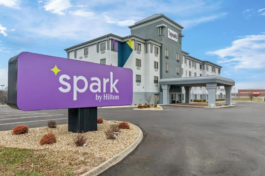a sign for a spark hotel in front of a building at Spark by Hilton Cincinnati Fairfield in Forest Park